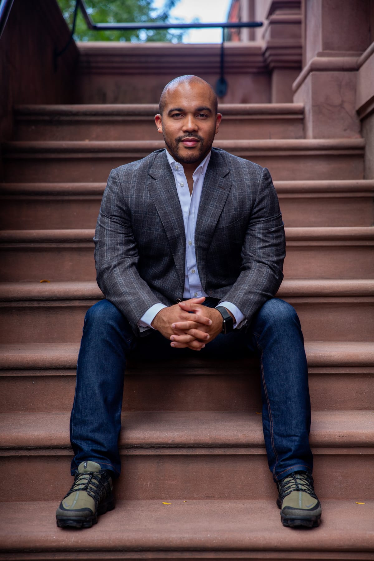 Akili Hinson standing on brownstone steps